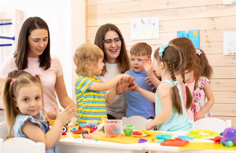 Kindergartener,With,Kids,Group,After,Lesson,In,Classroom